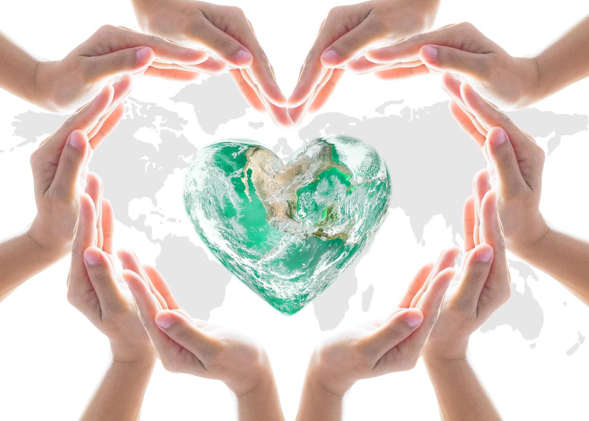 Caring hands encircling a heart-shaped world