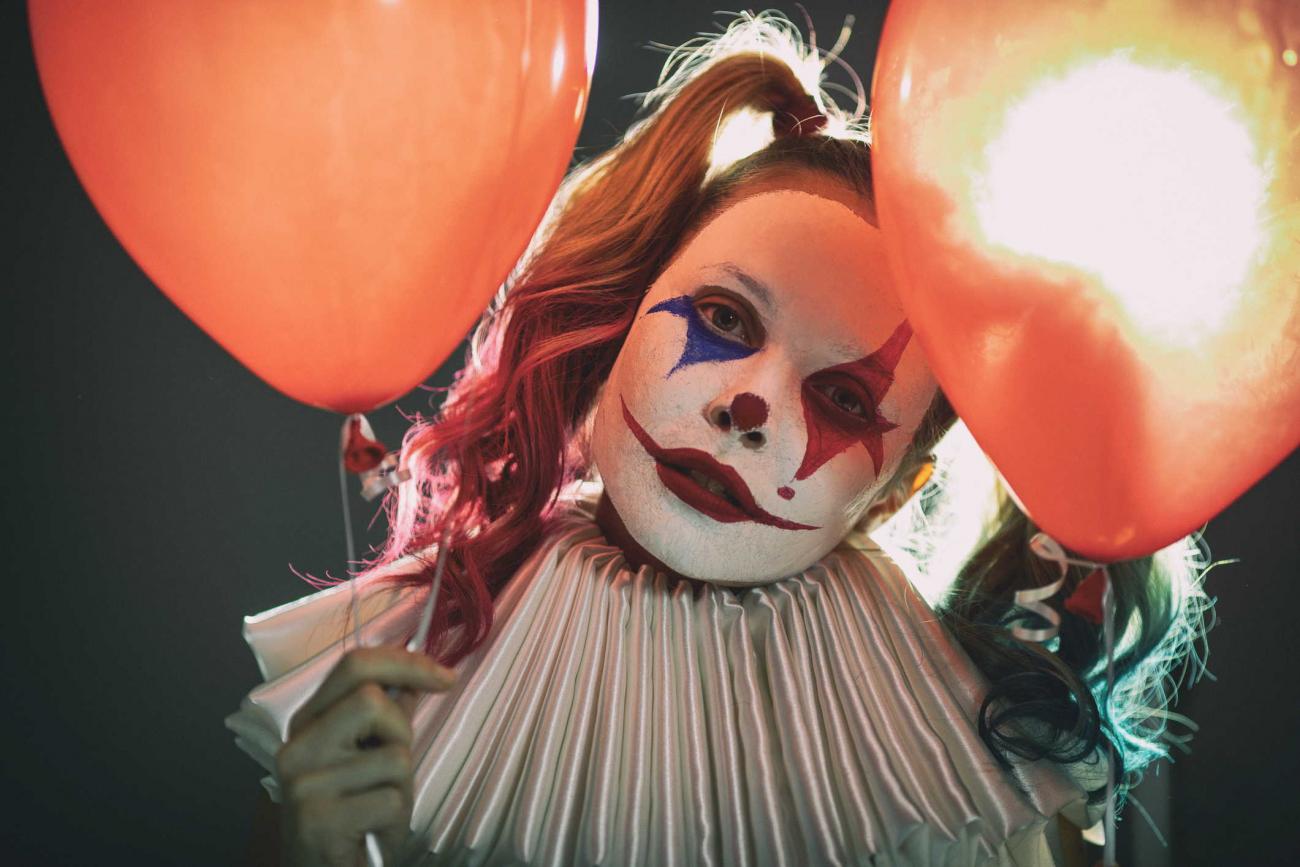 Evil clown with balloons